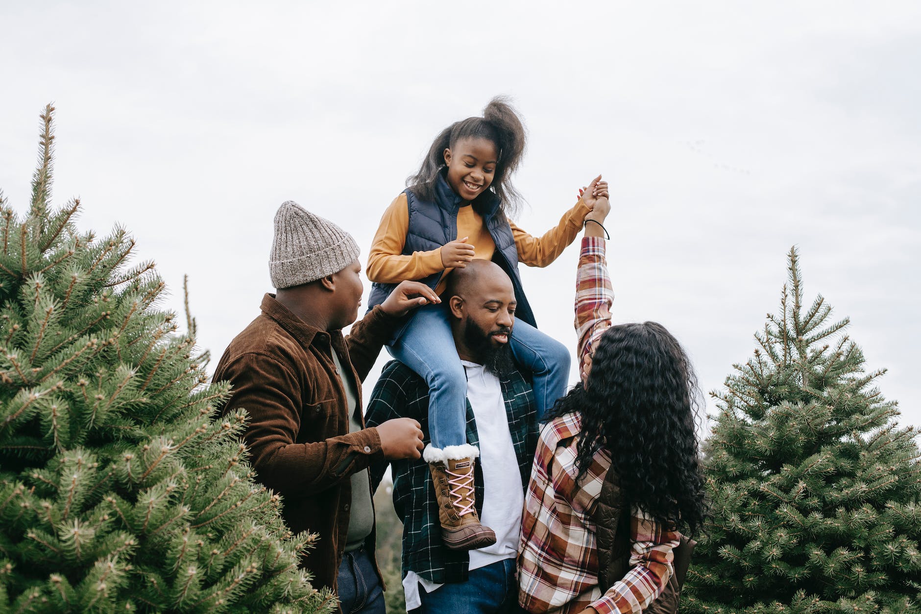 group of people standing on green grass field