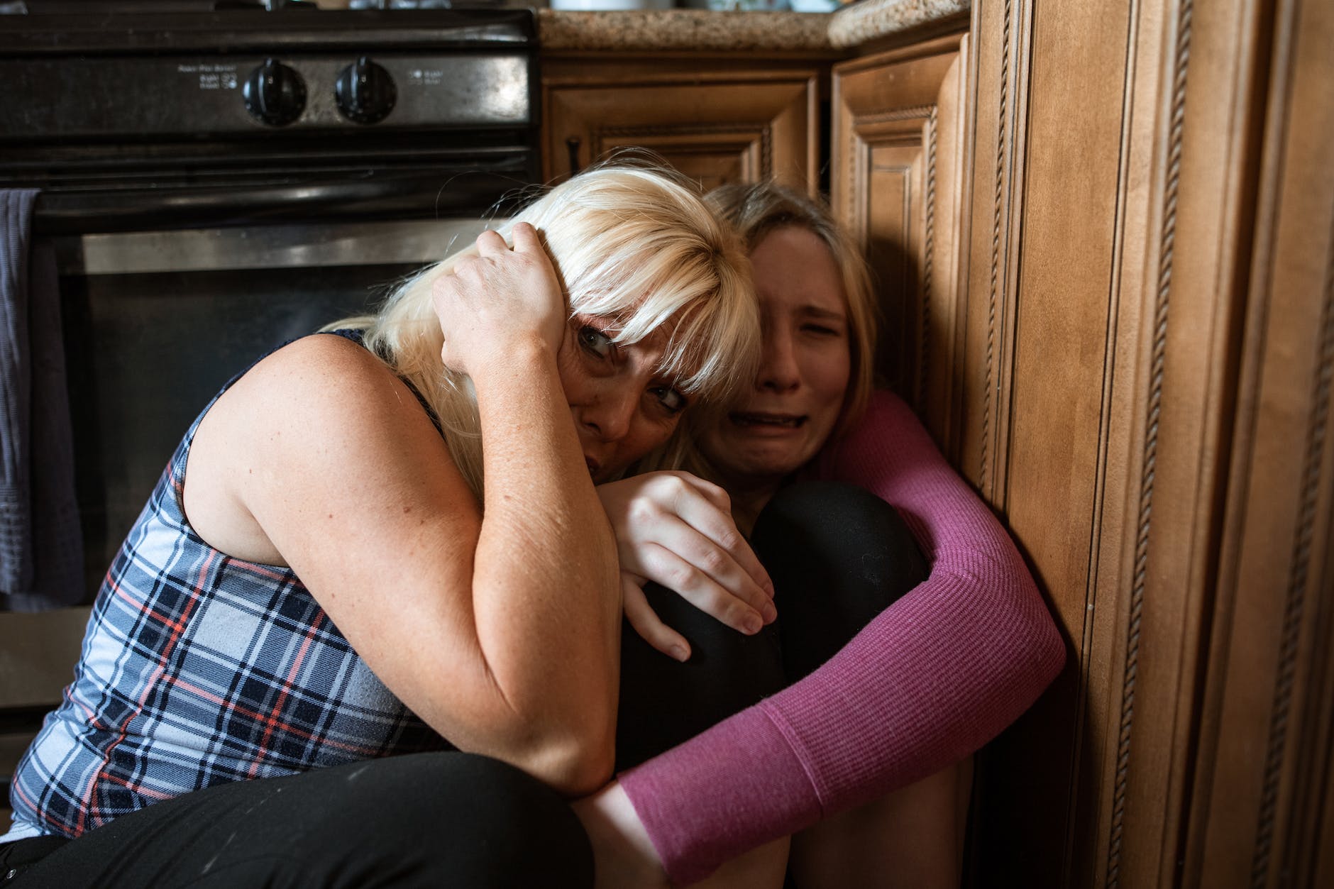 women sitting in a corner feeling scared