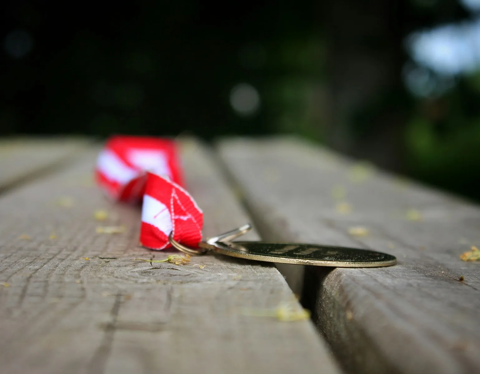 a red and white umbrella laying on top of a wooden table