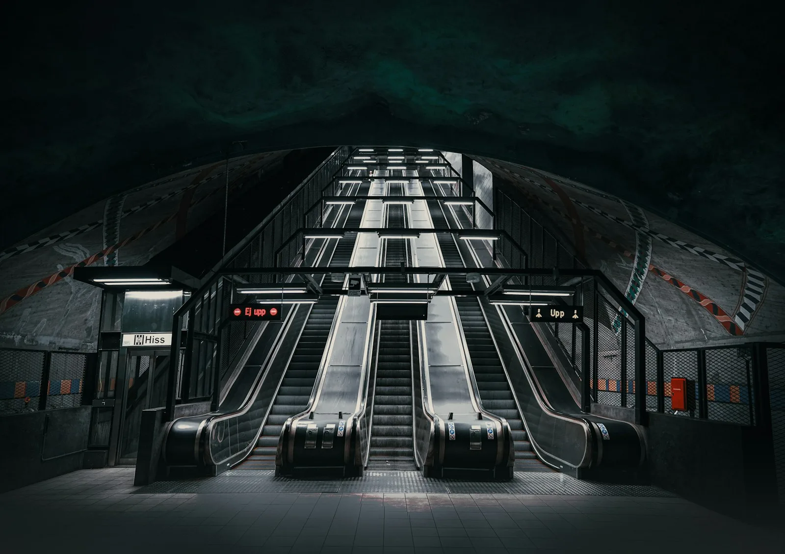 an escalator in a subway station at night