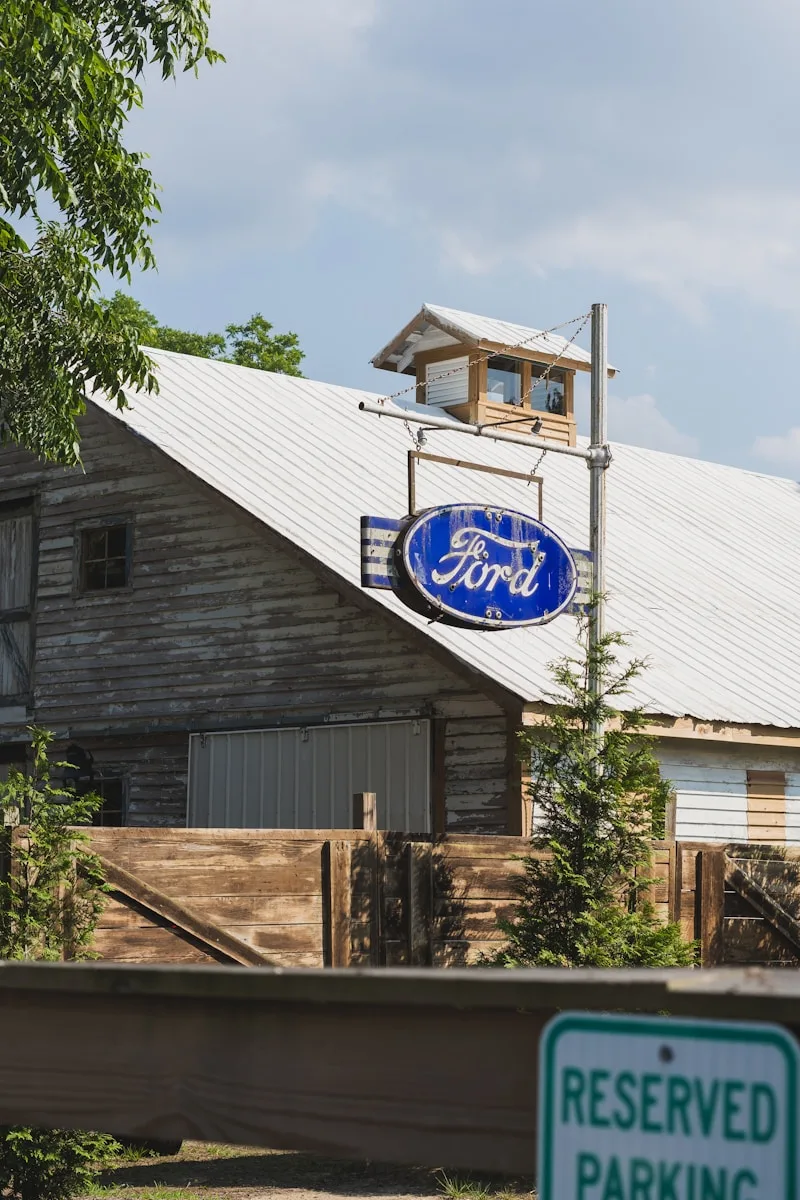 A blue ford sign sitting on the side of a building
