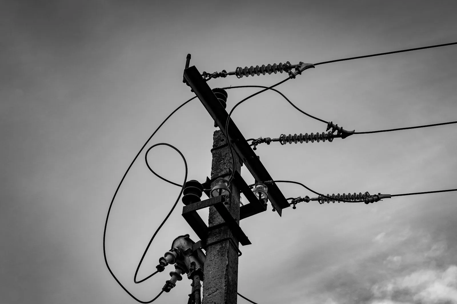 a black and white photo of a power pole