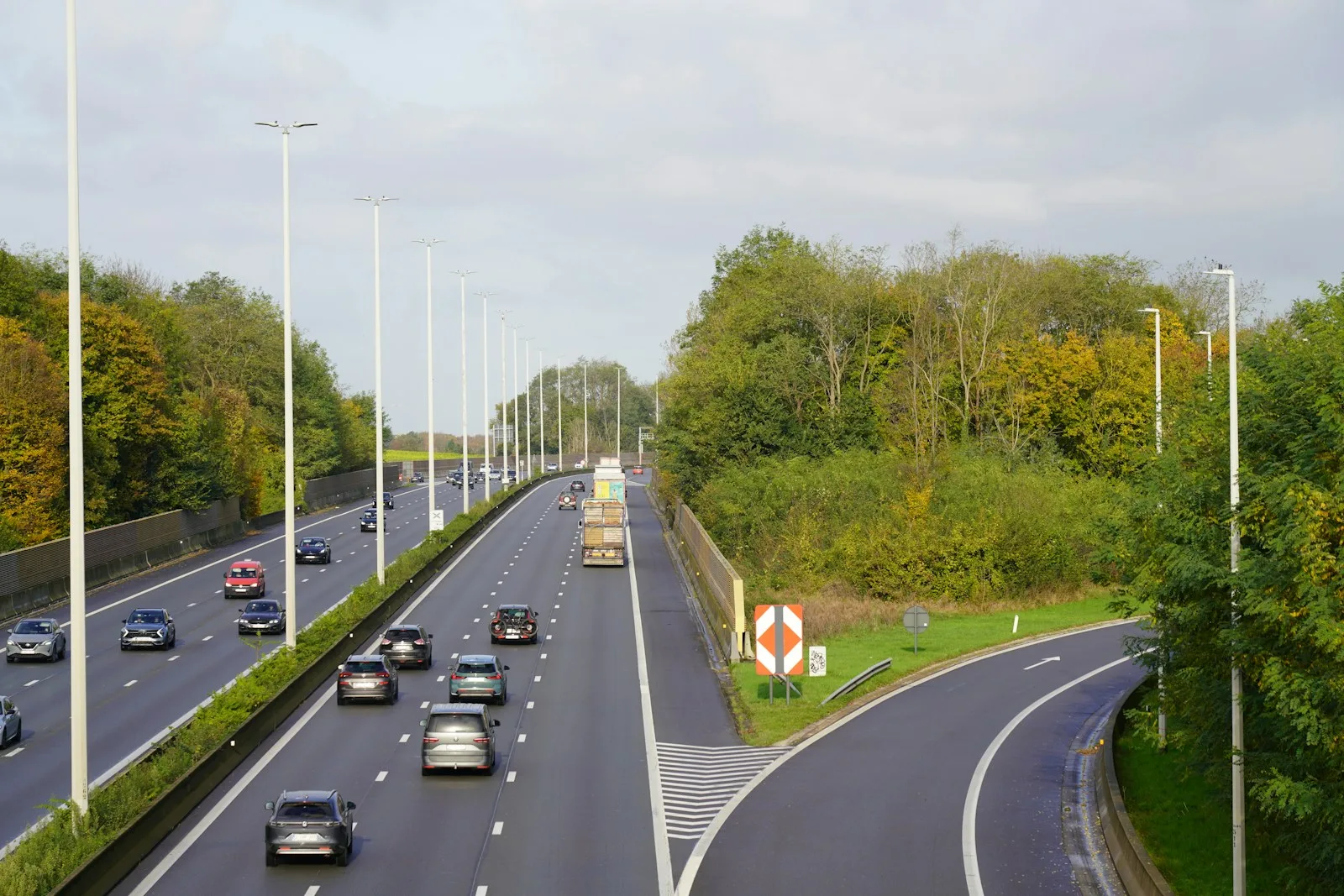 A highway with a bunch of cars driving down it