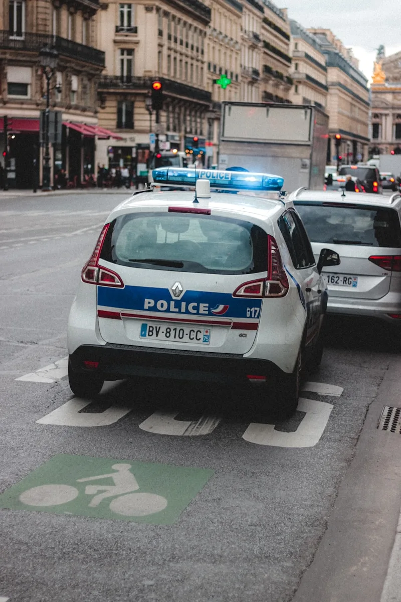 white and blue police car on road during daytime
