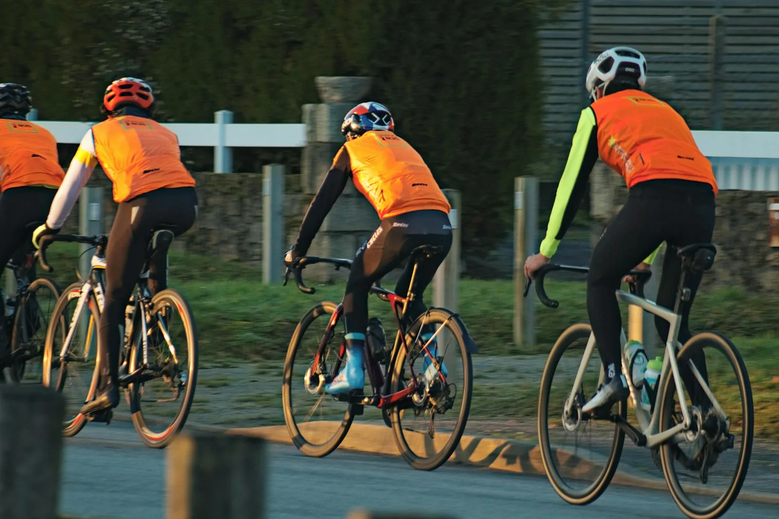 A group of people riding bikes down a street