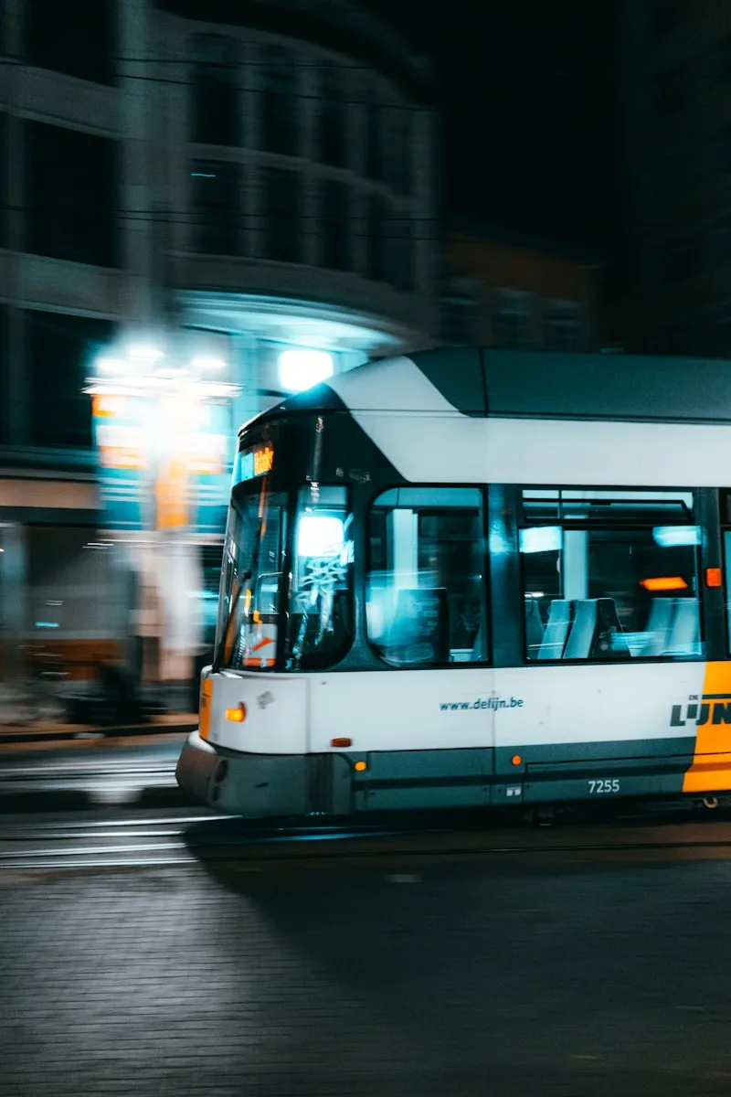 a bus driving down a street at night