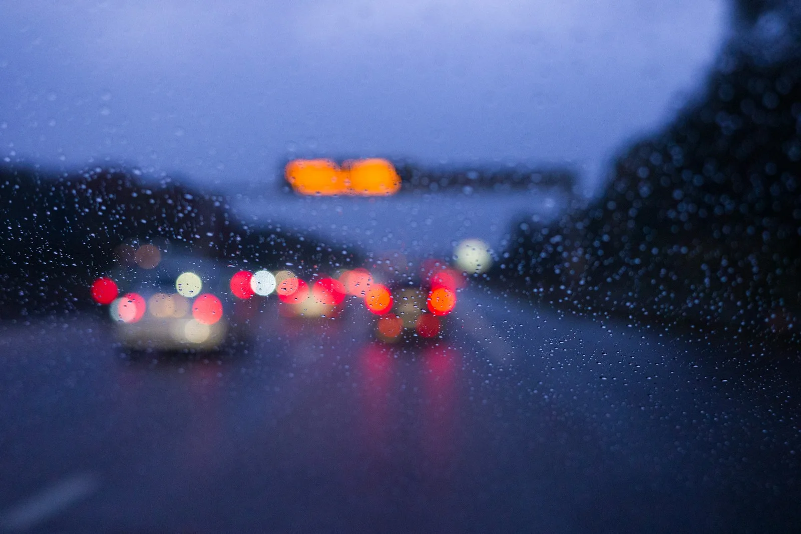 a blurry picture of cars on a rainy day