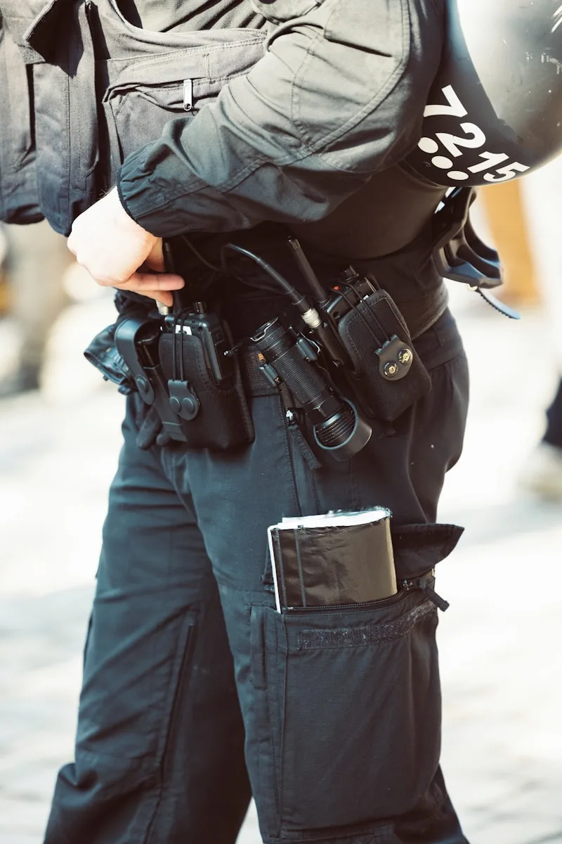 a police officer is holding a gun and a helmet