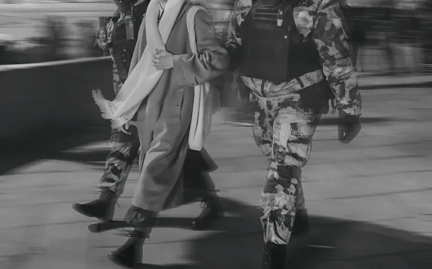 a couple of people that are walking down a sidewalk
