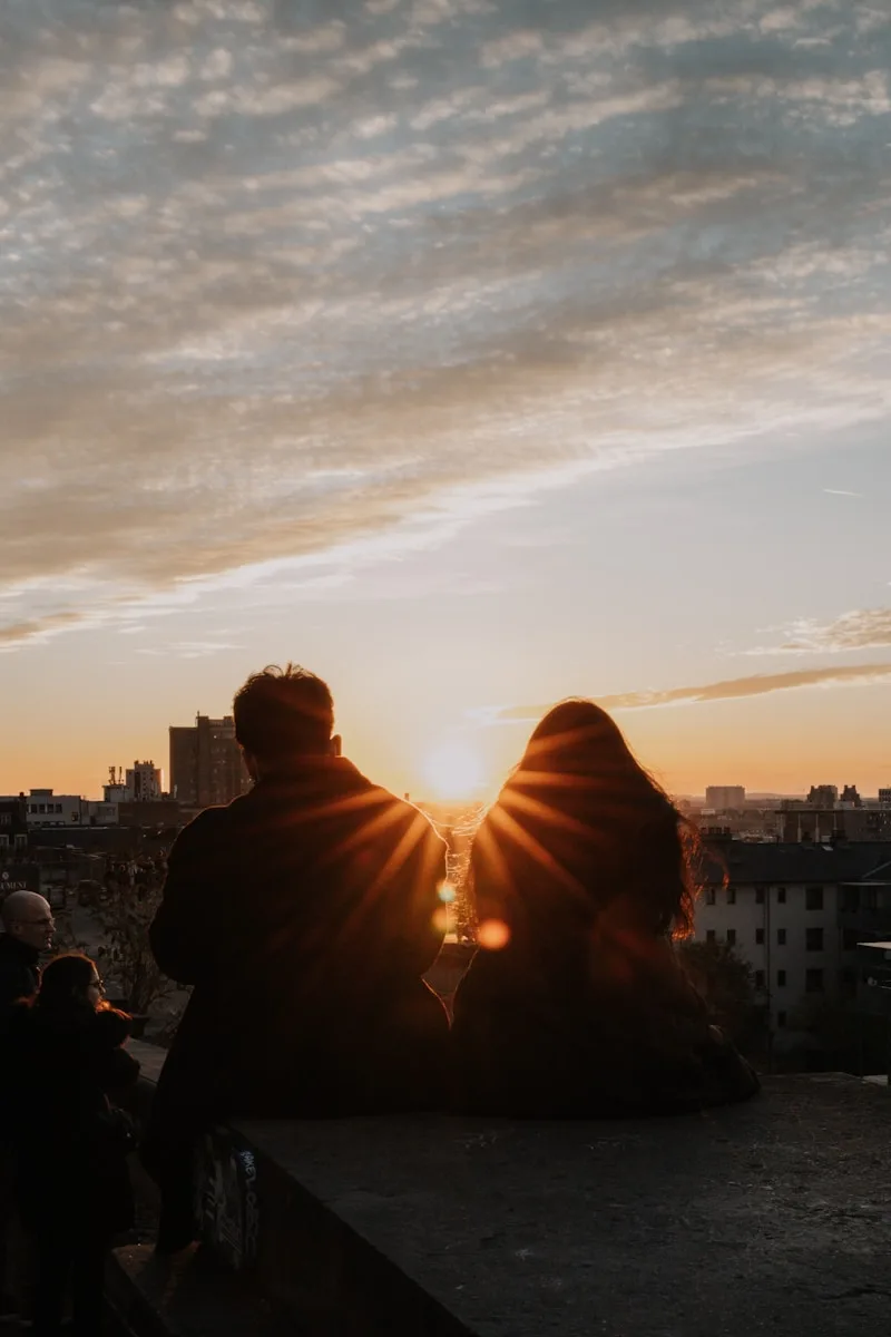 a couple of people sitting on top of a roof