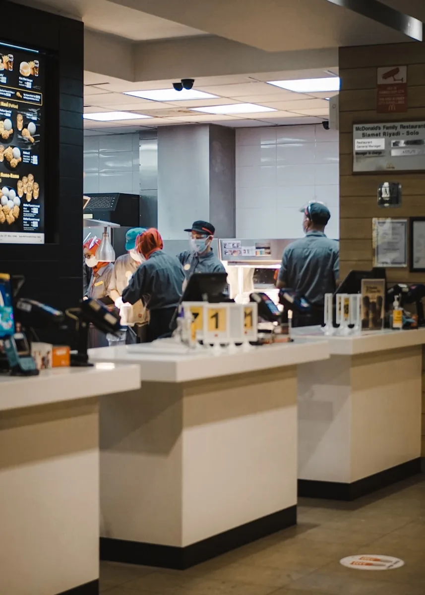 man in blue long sleeve shirt standing beside man in gray long sleeve shirt