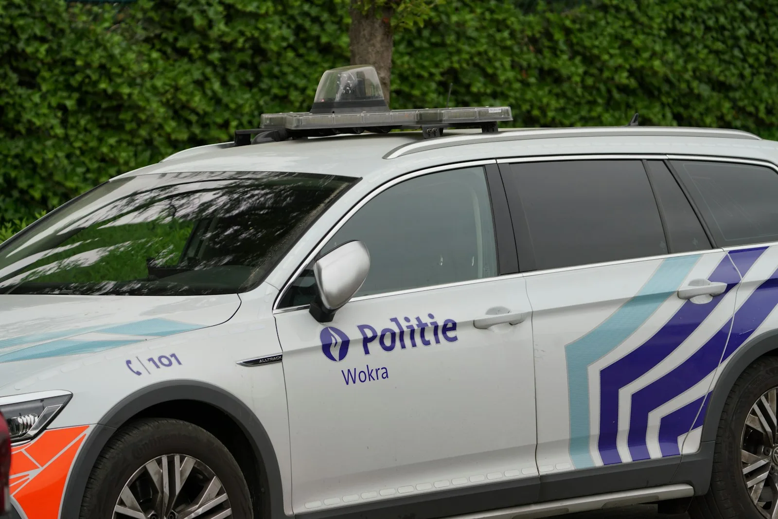 A police car with lights and signage is shown.