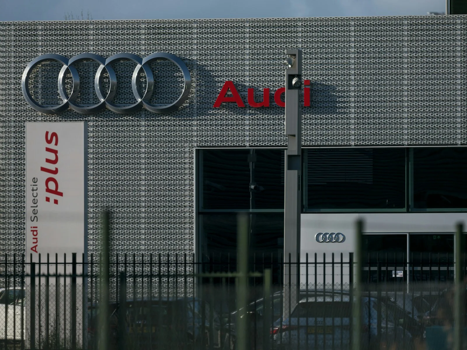 A car dealership with a sign that says audi