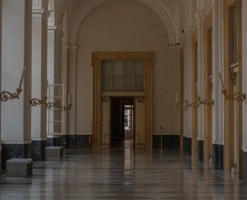 A long hallway with a clock on the wall