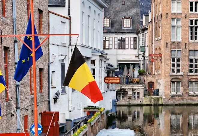 brown concrete building near body of water during daytime