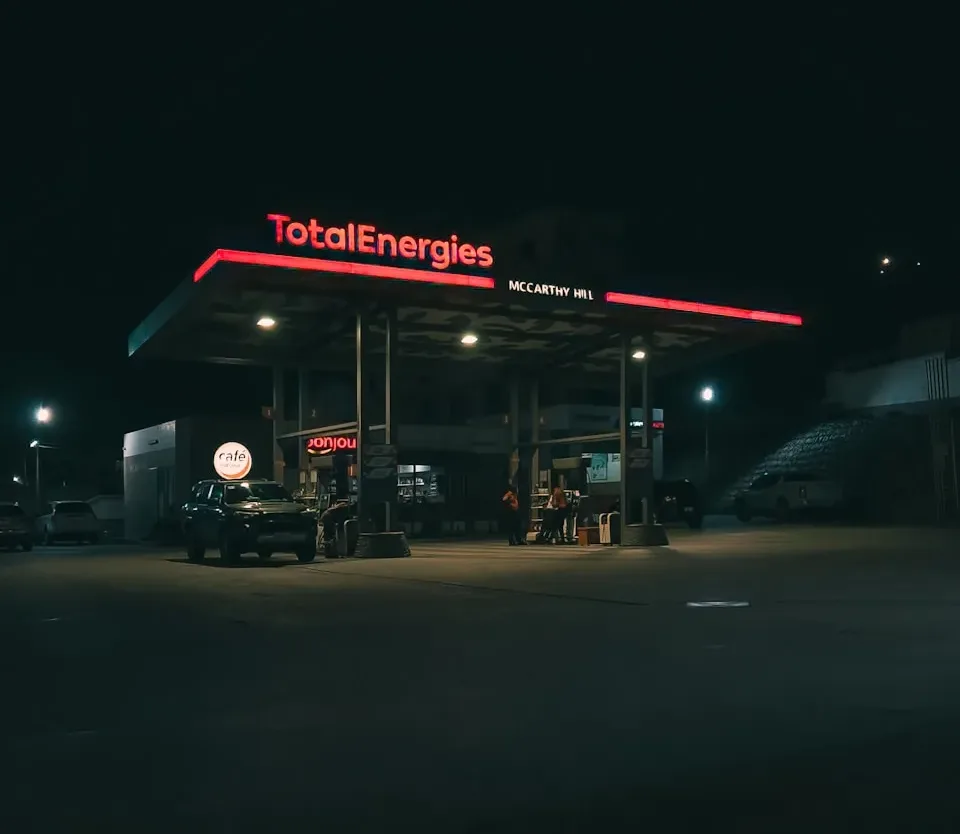 a gas station at night with the lights on