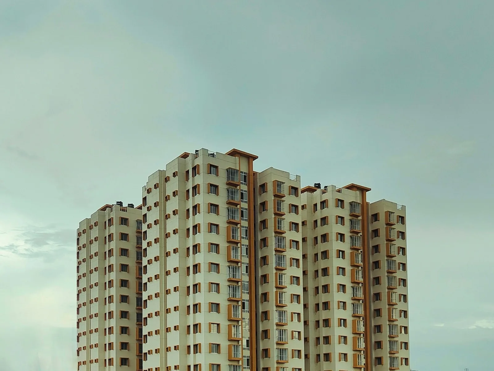 A very tall building sitting next to a body of water