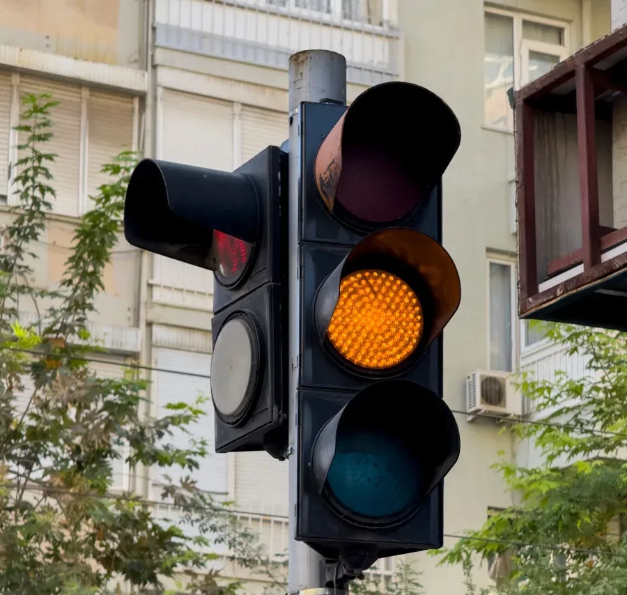 Traffic light shows yellow with no left turn sign.