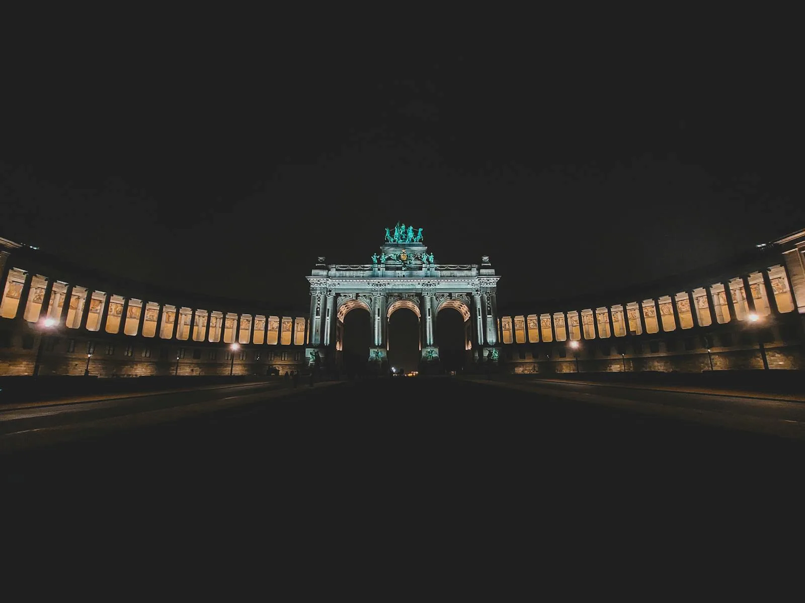 Illuminated Triumphal Arch at night in Parc du Cinquantenaire, Brussels, Belgium.