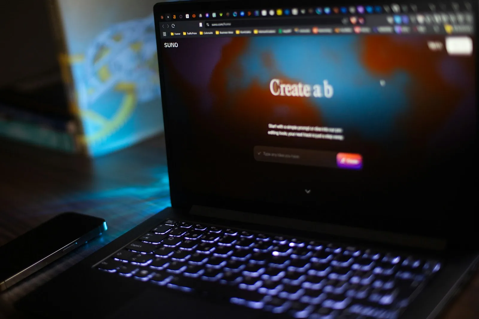 A laptop screen displays a "create a b" prompt.