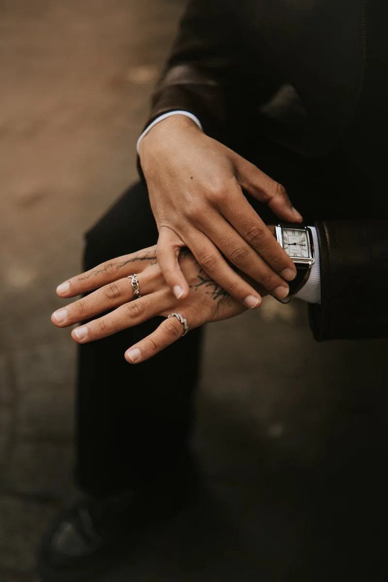 Close-up portrait of a fashionable man with tattoos and rings in Lille, France.