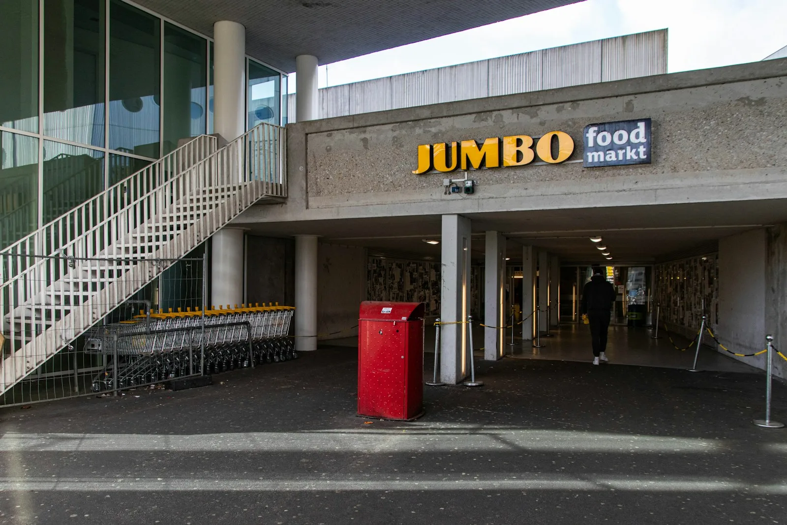 a jumbo food market with a red trash can