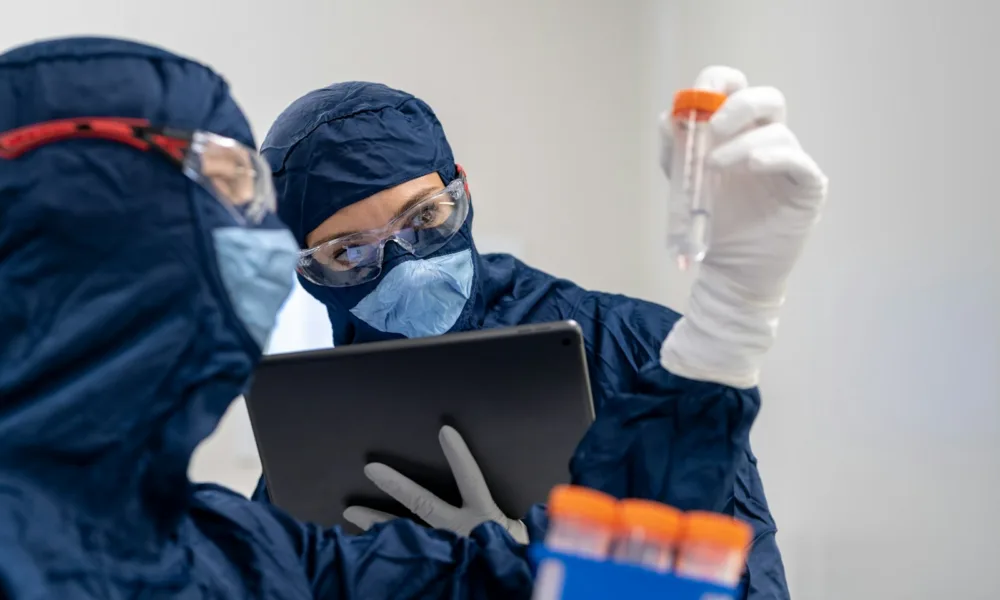 a person in a mask using a laptop