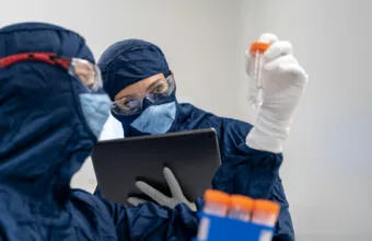 a person in a mask using a laptop