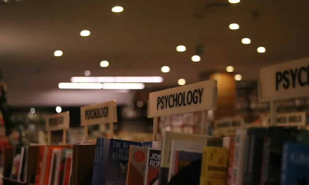 a row of books on a shelf in a library