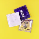 A couple of bags of candy sitting on top of a yellow table