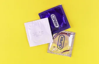 A couple of bags of candy sitting on top of a yellow table