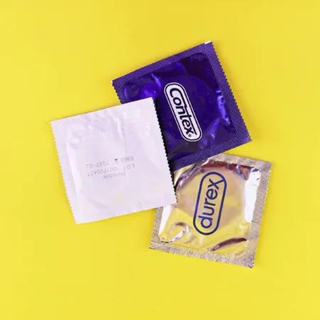 A couple of bags of candy sitting on top of a yellow table