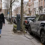 Samochód elektryczny podłączony do publicznej ładowarki na ulicy w Brukseli
