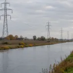 Słupy linii wysokiego napięcia wzdłuż kanału w Hainaut - wizualizacja